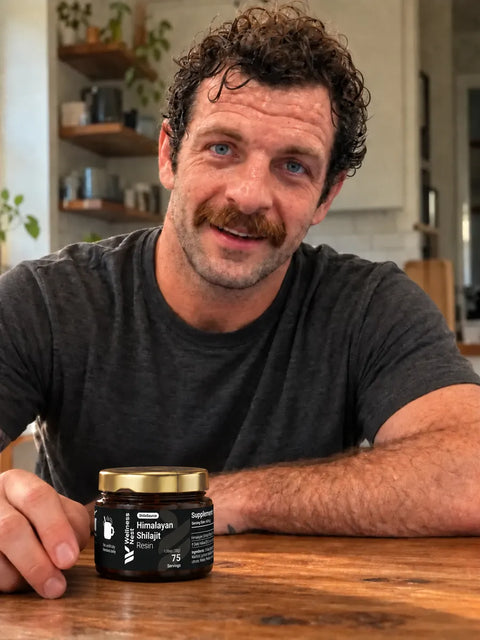 Mike Moretti, co-founder of Wellness Nest, smiling at his kitchen table with the ShilaSource jar beside his hand