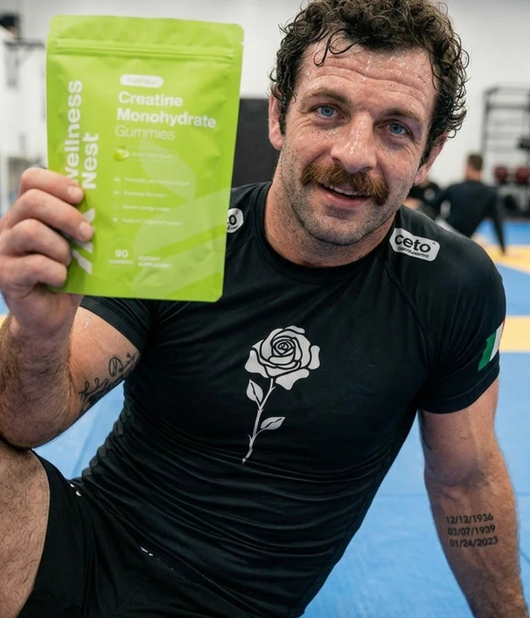 Mike Moretti, Wellness Nest co-founder, holding a FusiForce pouch on the jiu-jitsu mat