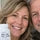 Candid portrait of Karen, 54, smiling warmly with her husband in their backyard